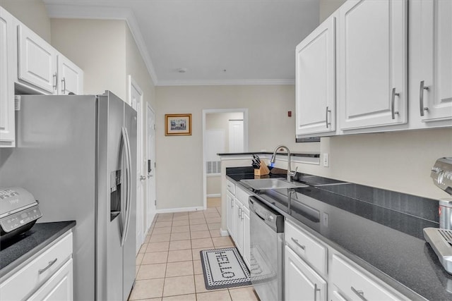 1000 Providence Pl Unit 201, Providence, RI 02903 - kitchen with ornamental molding, dark countertops, stainless steel appliances, white cabinetry, and light tile patterned floors