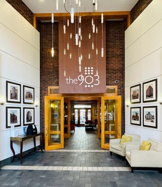1000 Providence Pl Unit 201, Providence, RI 02903 - lobby with a high ceiling and brick wall