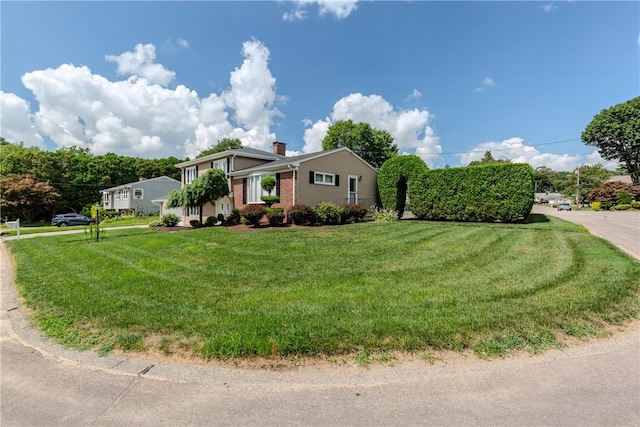 8 Sturbridge Ave, Smithfield, RI 02828 - view of front of property with a front yard and a chimney