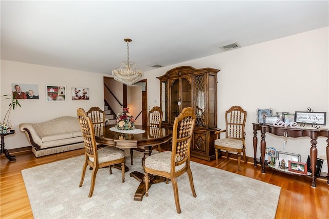 8 Sturbridge Ave, Smithfield, RI 02828 - dining area with a chandelier, stairway, and wood finished floors