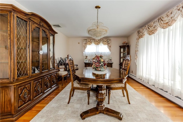 8 Sturbridge Ave, Smithfield, RI 02828 - dining space with a chandelier, light wood-type flooring, and baseboard heating