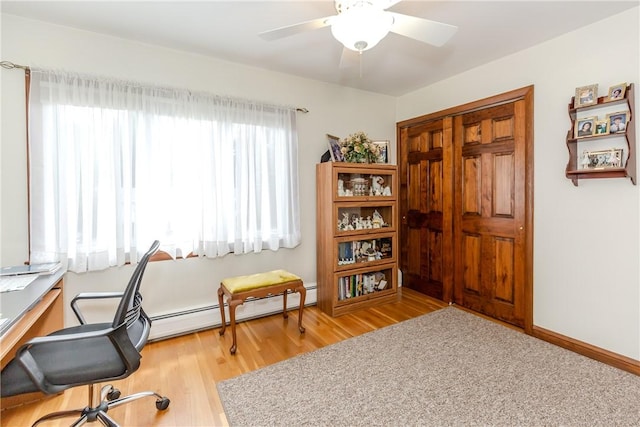 8 Sturbridge Ave, Smithfield, RI 02828 - office featuring light wood-style floors, a baseboard heating unit, and a ceiling fan