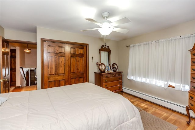 8 Sturbridge Ave, Smithfield, RI 02828 - bedroom featuring a baseboard radiator, a closet, wood finished floors, and a ceiling fan
