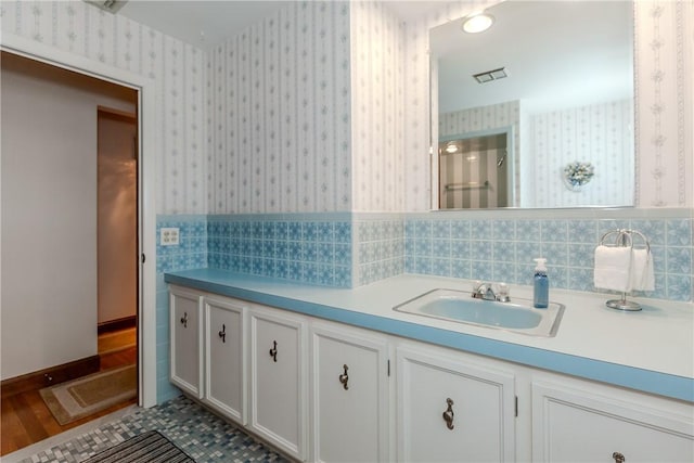 8 Sturbridge Ave, Smithfield, RI 02828 - bathroom with wallpapered walls, vanity, and wainscoting