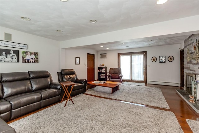 8 Sturbridge Ave, Smithfield, RI 02828 - living room with dark wood finished floors, a fireplace, recessed lighting, a baseboard radiator, and an AC wall unit