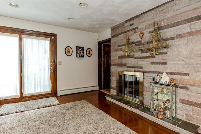 8 Sturbridge Ave, Smithfield, RI 02828 - living area with baseboard heating, wood finished floors, a fireplace, and recessed lighting