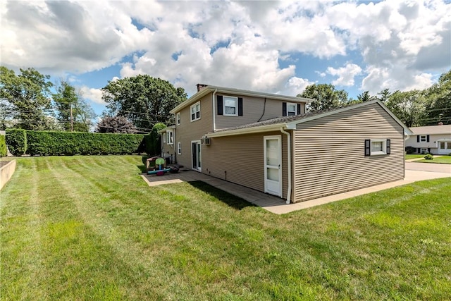 8 Sturbridge Ave, Smithfield, RI 02828 - back of property featuring a lawn and a patio area