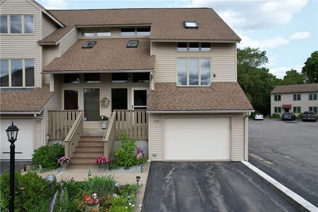 200 Cannon St Unit 130, Cranston, RI 02920 - view of front of house with a shingled roof, a garage, and asphalt driveway