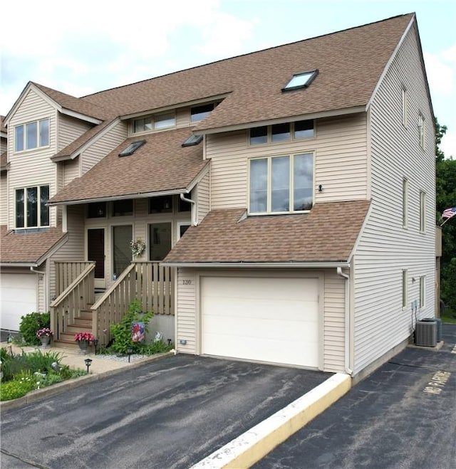 200 Cannon St Unit 130, Cranston, RI 02920 - view of front of house featuring an attached garage, driveway, and roof with shingles