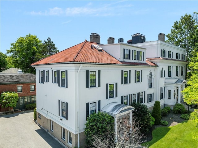 157 Waterman St Unit 2-5, Providence, RI 02906 - view of property exterior featuring a chimney, a tiled roof, and stucco siding