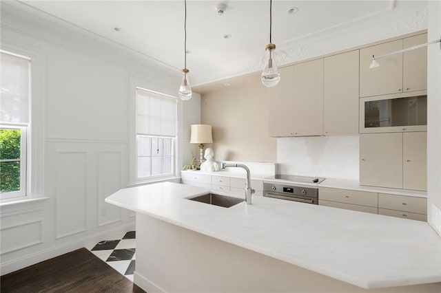 157 Waterman St Unit 2-5, Providence, RI 02906 - kitchen featuring a decorative wall, light countertops, crown molding, an island with sink, and hanging light fixtures