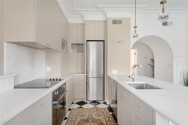 157 Waterman St Unit 2-5, Providence, RI 02906 - kitchen with stainless steel appliances, light countertops, crown molding, decorative light fixtures, and arched walkways