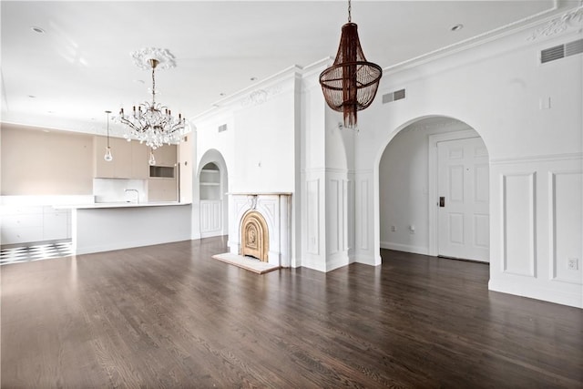 157 Waterman St Unit 2-5, Providence, RI 02906 - unfurnished living room with a chandelier, wood finished floors, arched walkways, a decorative wall, and ornamental molding