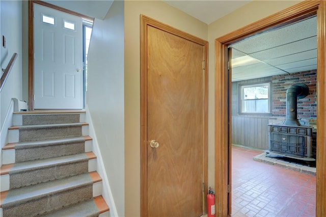 123 S Comstock Pkwy, Cranston, RI 02921 - stairway featuring a wood stove and brick patterned flooring