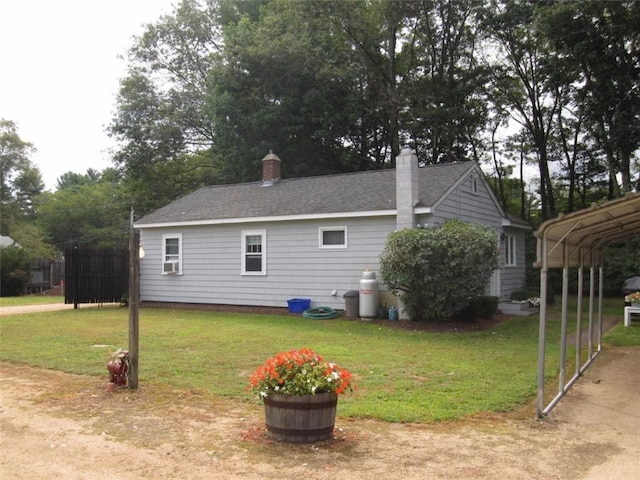 view of side of home with a carport and a lawn