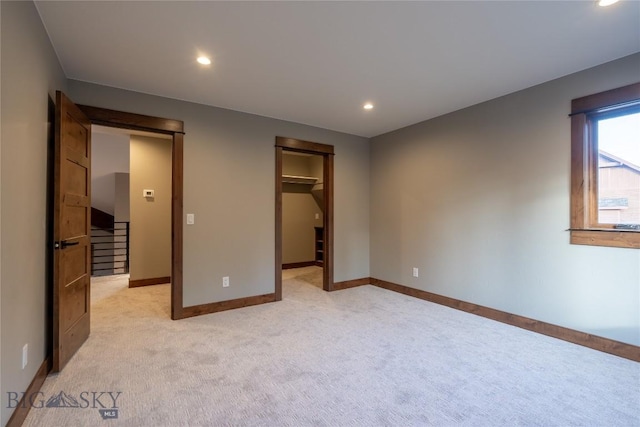 27A Heavy Runner Rd Unit 27A, Big Sky, MT 59716 - unfurnished bedroom featuring light carpet, recessed lighting, and a spacious closet