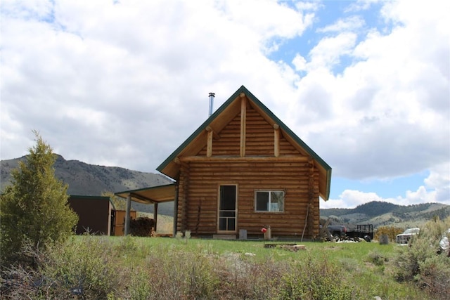 rear view of house featuring a mountain view