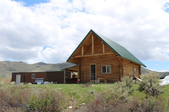 back of property featuring a mountain view