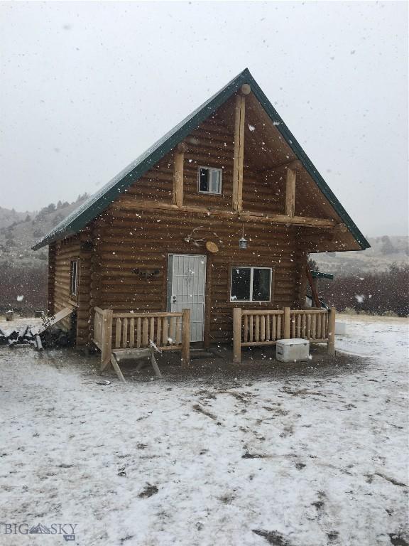 view of snow covered back of property