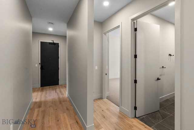 hall featuring recessed lighting, baseboards, visible vents, and light wood finished floors