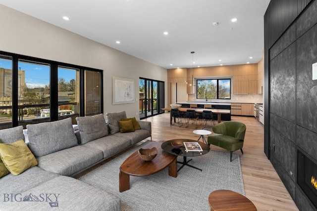 living area featuring recessed lighting and light wood-style flooring