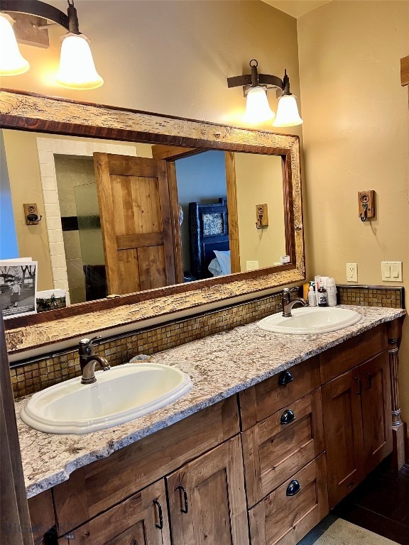 bathroom featuring tasteful backsplash and dual bowl vanity