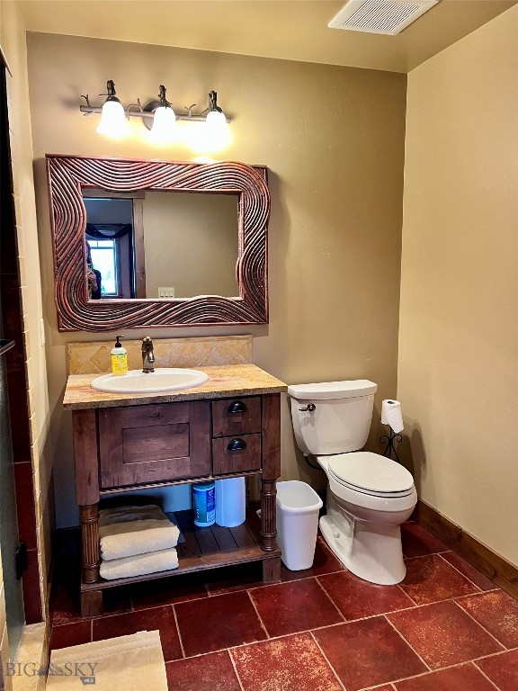 bathroom featuring tile floors, toilet, and vanity