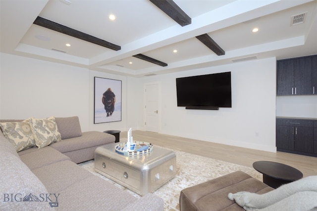 living room featuring beamed ceiling and light wood-type flooring