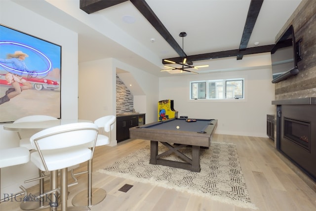 rec room with beam ceiling, pool table, and light hardwood / wood-style flooring