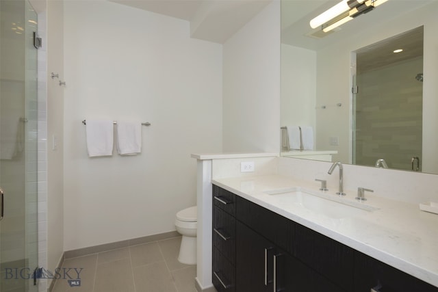 bathroom featuring tile patterned flooring, vanity, toilet, and an enclosed shower