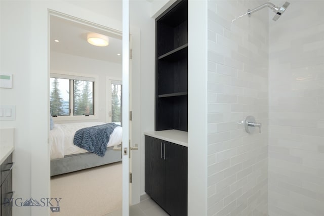 bathroom featuring vanity and a tile shower