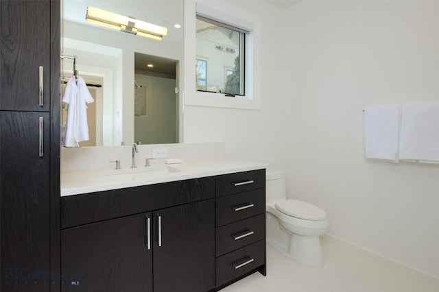 bathroom with vanity, toilet, and walk in shower