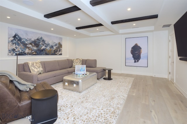 living room featuring beamed ceiling and light hardwood / wood-style floors