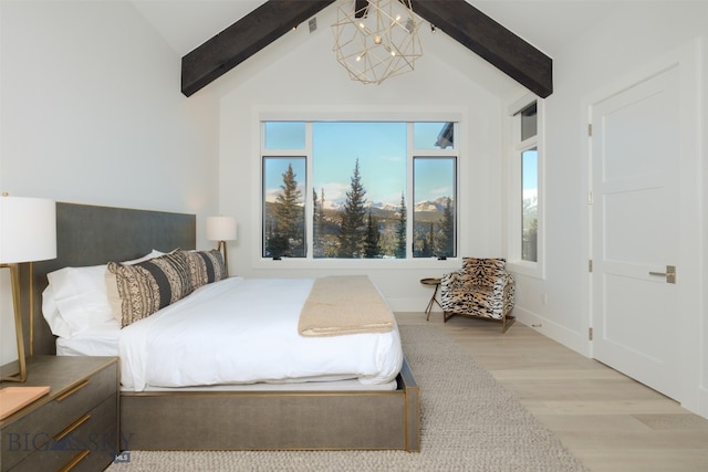 bedroom with hardwood / wood-style floors, vaulted ceiling with beams, and an inviting chandelier