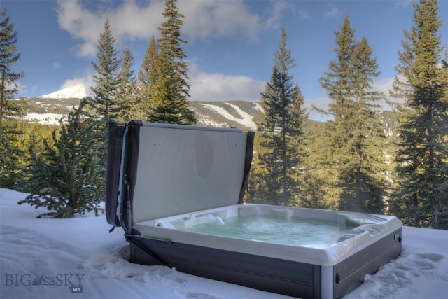 exterior details featuring a mountain view and a hot tub