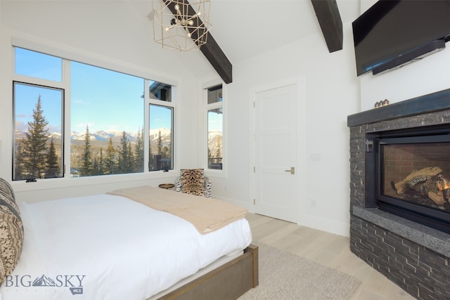 bedroom with beam ceiling, light hardwood / wood-style flooring, and a notable chandelier