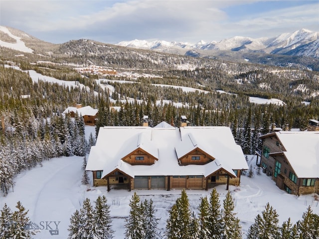 snowy aerial view featuring a mountain view