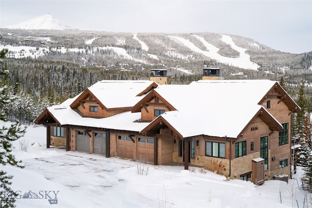 view of front facade featuring a mountain view and a garage