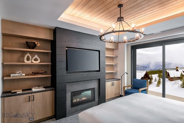 bedroom featuring a tray ceiling, a fireplace, wooden ceiling, and a notable chandelier