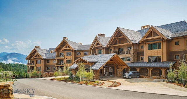 view of building exterior with driveway and a mountain view