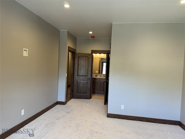 unfurnished room with light colored carpet