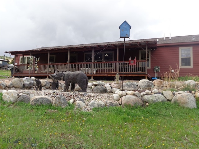 back of house featuring a wooden deck