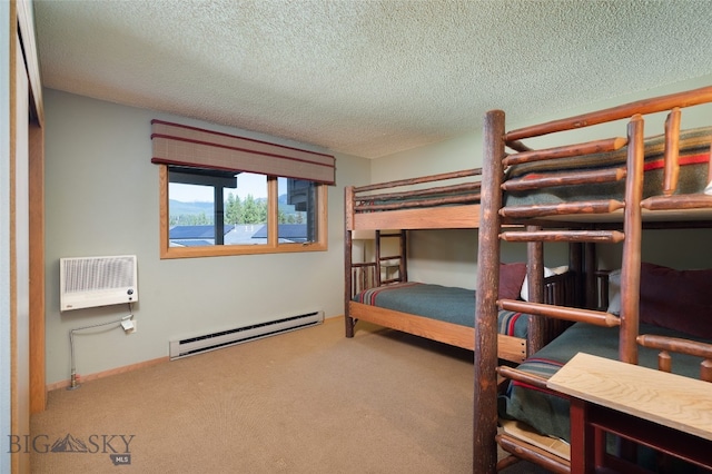 bedroom with a wall mounted AC, a textured ceiling, a baseboard radiator, and carpet