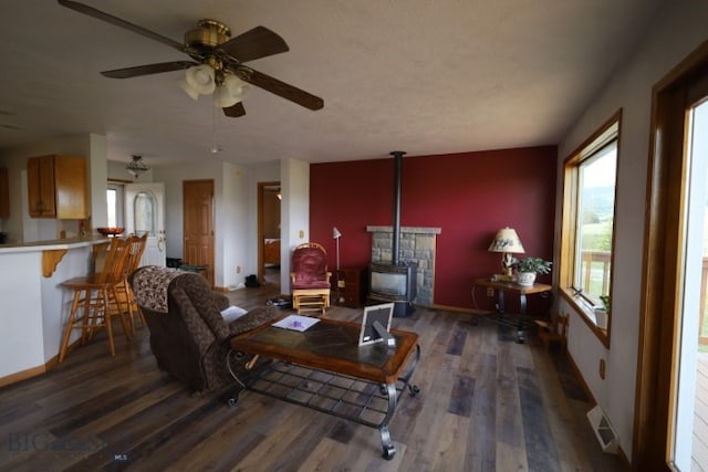 living room featuring ceiling fan and dark hardwood / wood-style floors