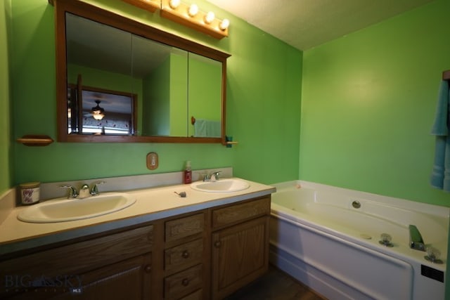 bathroom with dual sinks, a bathing tub, and oversized vanity