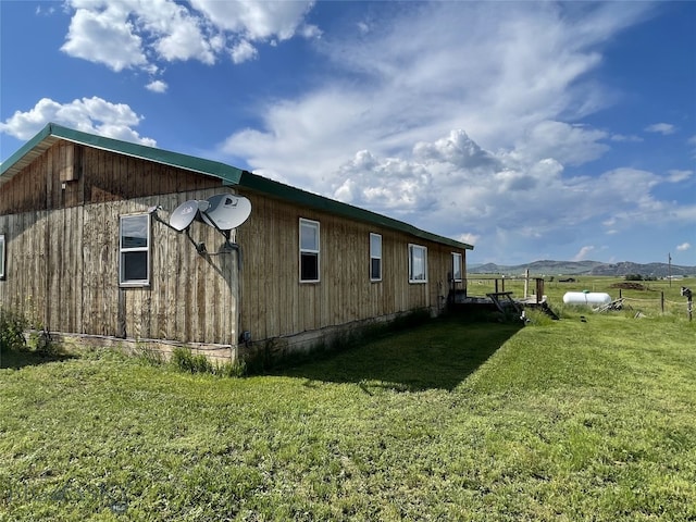 view of property exterior featuring a lawn