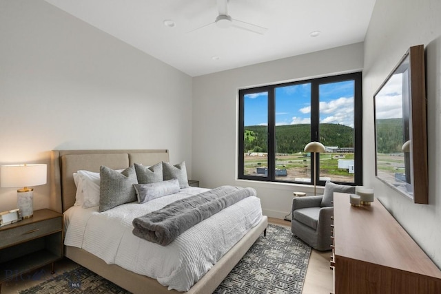 bedroom featuring wood-type flooring and ceiling fan