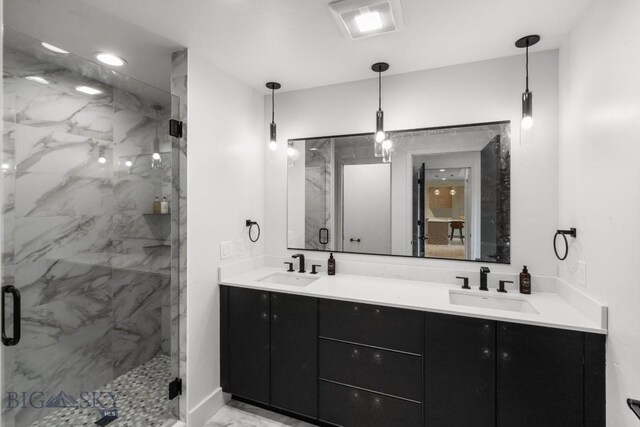 bathroom featuring a shower with door and vanity