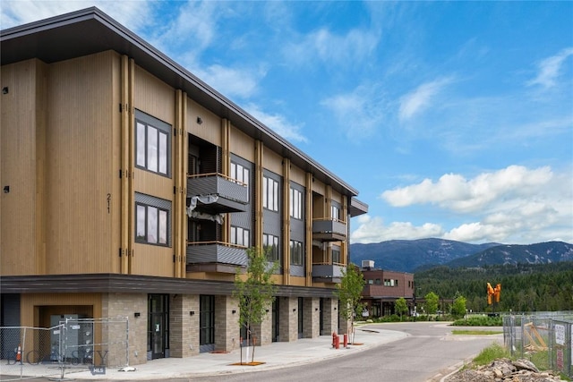 211 Town Center Ave Unit 2D, Big Sky, MT 59716 - view of property with a mountain view and fence