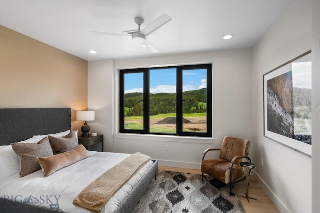 bedroom with ceiling fan and hardwood / wood-style floors